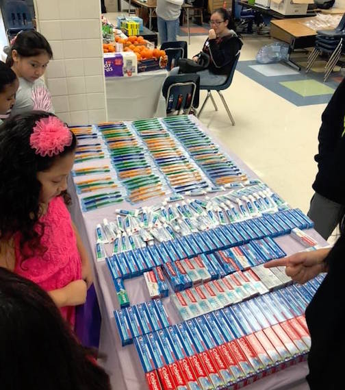 Photo of girls selecting a toothbrush and tooth paste